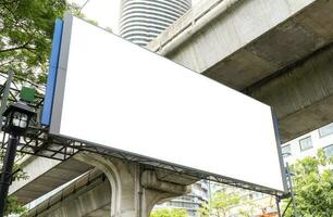 Outdoor LED display billboard with mock up white screen on footpath. clipping path for mockup photo