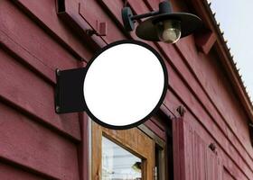 Outdoor white circle sign on wall photo