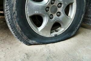 Close up wheel car and leaking tire photo