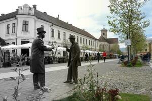 Alba Iulia , Romania - May 1 2023 , The multitude of statues made of bronze that can be found near the center of the fortress.This statues present different status of the people back days photo