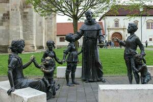 Alba Iulia , Romania - May 1 2023 , The multitude of statues made of bronze that can be found near the center of the fortress.This statues present different status of the people back days photo