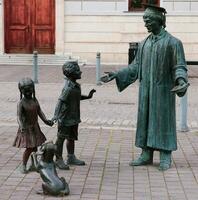 Alba Iulia , Romania - May 1 2023 , The multitude of statues made of bronze that can be found near the center of the fortress.This statues present different status of the people back days photo