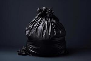 Black trash bag isolated on black background. photo