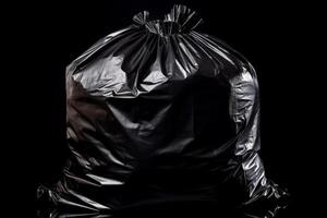 Black trash bag isolated on black background. photo