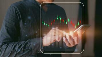 Businessman touching chart on smartphone screen. Investment stock market concept, stock investor photo