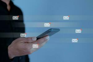 Businessman using smartphone with email icon, email inbox electronic communication graphic concept. photo