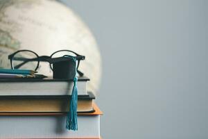 Graduation cap with Earth globe. Concept of global business study, abroad educational, Back to School. Education in Global world, Study abroad business in universities in worldwide. language study photo