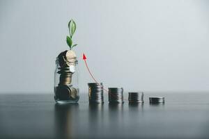 Save money, success goals and investment growth concept. Tree growing on stack coins with arrows rising on blur office background. Financial and business, Management money retire, tax. photo