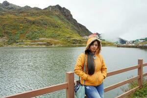 Young age Tourist Girl Standing beside Tsomgo or Changu Lake at East Sikkim During Silk Route Tour photo