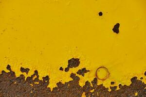 Yellow painted steel plate with rust photo