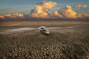 de madera barco en clima sequía, terreno agrietado suelo en caliente clima foto