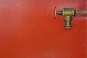 Fire hose on red background photo