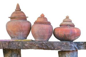 clay jar on wood table isolated on white background. Clipping path photo