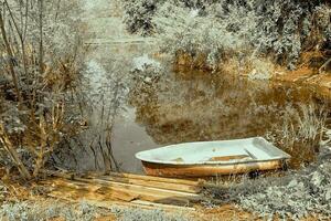 Boat in canal landscape. infrared nature landscape photo