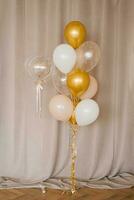 Decor for the celebration of the 30th anniversary. Balloons of gold and white color photo