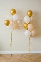 Decor for the celebration of the 30th anniversary. Balloons of gold and white color photo