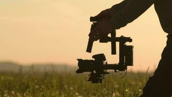 Video Camera Operator. Videography Theme. DSLR Camera on the Gimbal Stabilization Device. Film Production. Slow Motion Footage