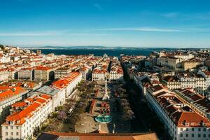 Aerial drone view of Rossio square, with the Tagus river in background in the Baixa district of Lisbon, Portugal photo