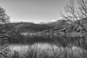 Nordfjord in Norway in black and white. View of mountains covered with snow. photo