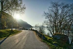 Parking lot overlooking the road, the Nordfjord and Bergen in Norway. Sun rays photo