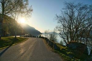 Parking lot overlooking the road, the Nordfjord and Bergen in Norway. Sun rays photo