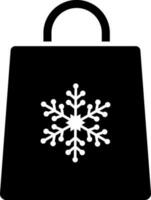 Snowflake symbol on shopping bag glyph icon. vector