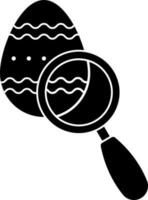 Easter egg in the magnifying glass glyph icon. vector