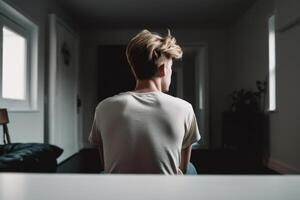 teen depression loneliness, young male guy in an empty room photo