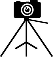 Camera on tripod. Glyph icon or symbol. vector