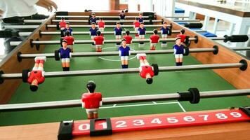 a mini soccer table with red and blue teams photo