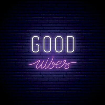 Good vibes neon signboard. Glowing quote on brick wall background.