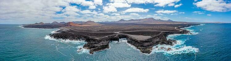 Drone panorama of volcanic coast near El Golfo on Lanzarote with Playa del Paso during daytime photo