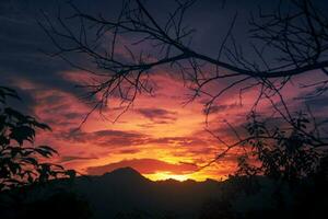 Beautiful sunset sky with mountain silhouette photo