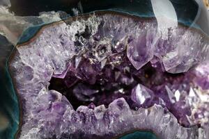 Macro Mineral Stone Amethysts in the rock on a white background photo