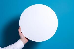 circle empty white mockup in hand on blue background photo