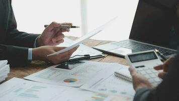 Financial analysts analyze business financial reports on a digital tablet planning investment project during a discussion at a meeting of corporate showing the results of their successful teamwork. video