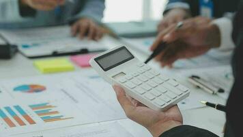 Financial analysts analyze business financial reports on a digital tablet planning investment project during a discussion at a meeting of corporate showing the results of their successful teamwork. video