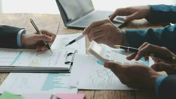 Financial analysts analyze business financial reports on a digital tablet planning investment project during a discussion at a meeting of corporate showing the results of their successful teamwork. video