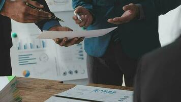 Financial analysts analyze business financial reports on a digital tablet planning investment project during a discussion at a meeting of corporate showing the results of their successful teamwork. video