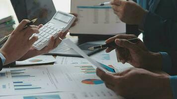Financial analysts analyze business financial reports on a digital tablet planning investment project during a discussion at a meeting of corporate showing the results of their successful teamwork. video