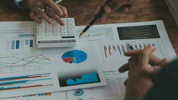 Financial analysts analyze business financial reports on a digital tablet planning investment project during a discussion at a meeting of corporate showing the results of their successful teamwork. video