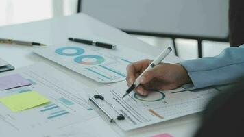 Financial analysts analyze business financial reports on a digital tablet planning investment project during a discussion at a meeting of corporate showing the results of their successful teamwork. video