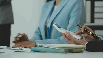 Financial analysts analyze business financial reports on a digital tablet planning investment project during a discussion at a meeting of corporate showing the results of their successful teamwork. video