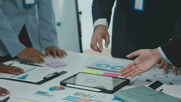 Financial analysts analyze business financial reports on a digital tablet planning investment project during a discussion at a meeting of corporate showing the results of their successful teamwork. video