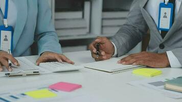 Financial analysts analyze business financial reports on a digital tablet planning investment project during a discussion at a meeting of corporate showing the results of their successful teamwork. video