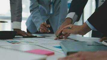 Financial analysts analyze business financial reports on a digital tablet planning investment project during a discussion at a meeting of corporate showing the results of their successful teamwork. video