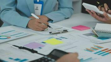 Financial analysts analyze business financial reports on a digital tablet planning investment project during a discussion at a meeting of corporate showing the results of their successful teamwork. video