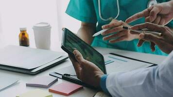 Concentrated medical team using laptop together in the office video