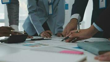 Financial analysts analyze business financial reports on a digital tablet planning investment project during a discussion at a meeting of corporate showing the results of their successful teamwork. video