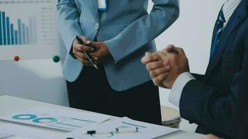 grupo do colegas de trabalho dentro formal vestem sentado às mesa dentro conferência quarto e discutindo sobre projeto do companhia desenvolvimento durante encontro video